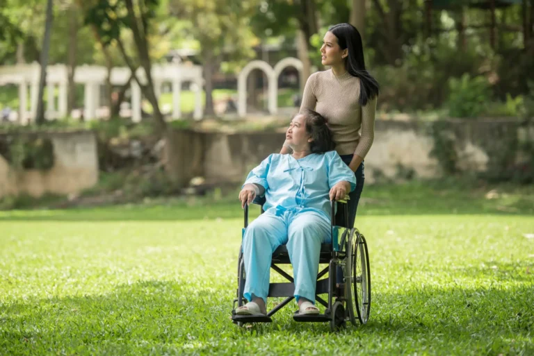 A carer help to a women in a wheelchair
