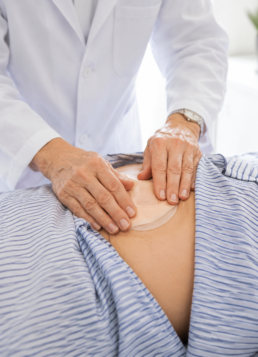 Healthcare professional providing stoma management support to an elderly patient