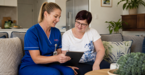 A registered nurse conducting an NDIS nursing assessment in a participant's home.